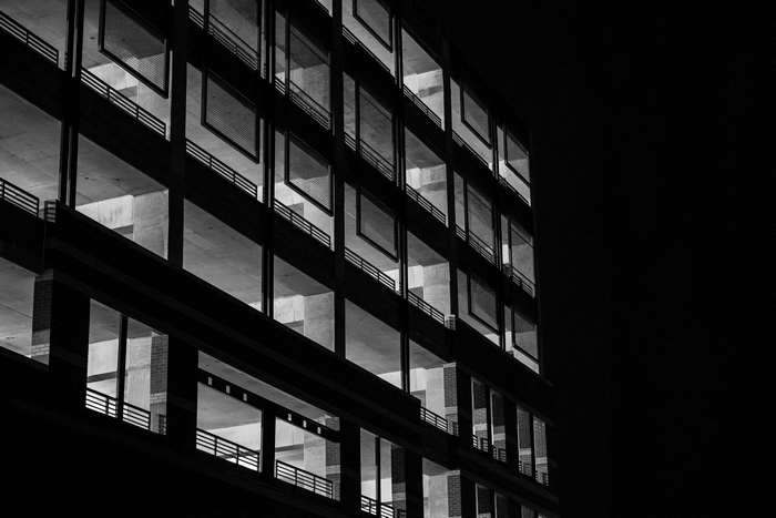 Black and white multi-storey parking garage at night
