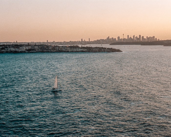 Sailboat on the water with Sydney skyline in the background