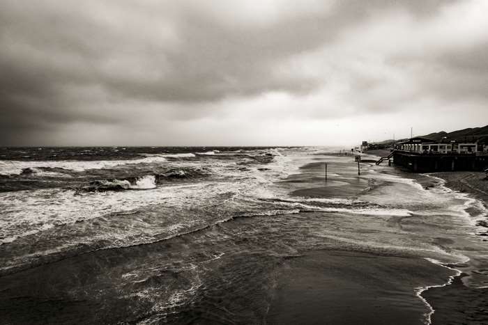 Stormy Ocean Waves on a Beach with Building