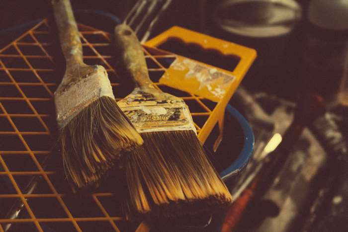 Paint brushes on a grid and bucket