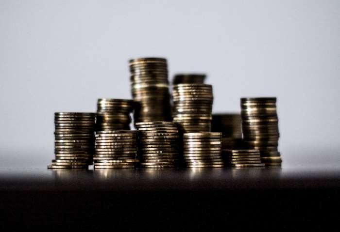 Stacks of gold coins on a dark surface