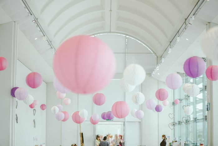 Pink and purple paper lanterns hanging indoors