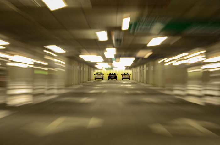 Cars in a blurry underground parking lot
