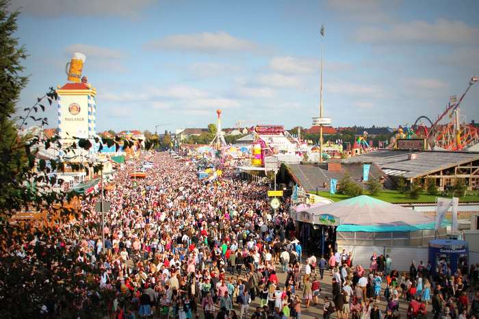 Oktoberfest crowd with beer tents and amusement rides