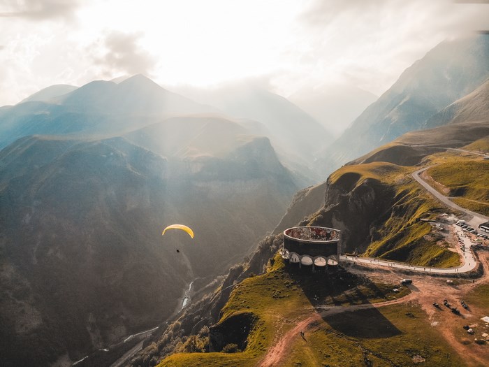 Paraglider over mountains in Georgia