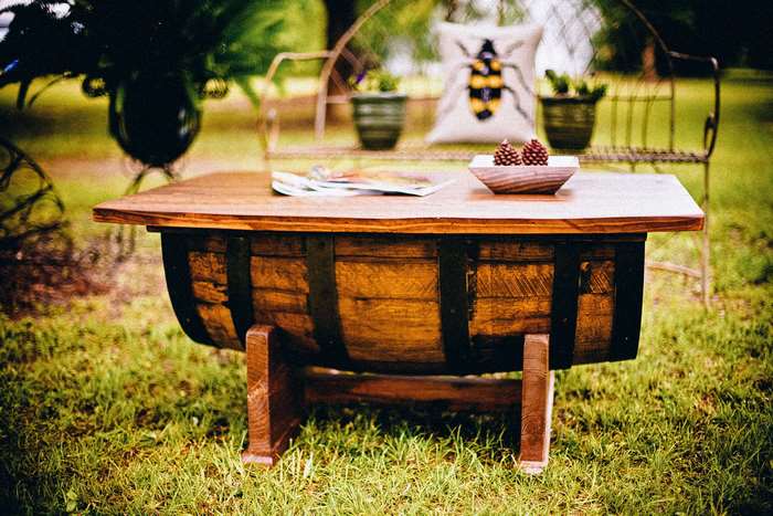 Rustic wooden barrel coffee table in a backyard 4K