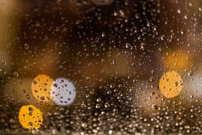 Raindrops on a window with bokeh lights