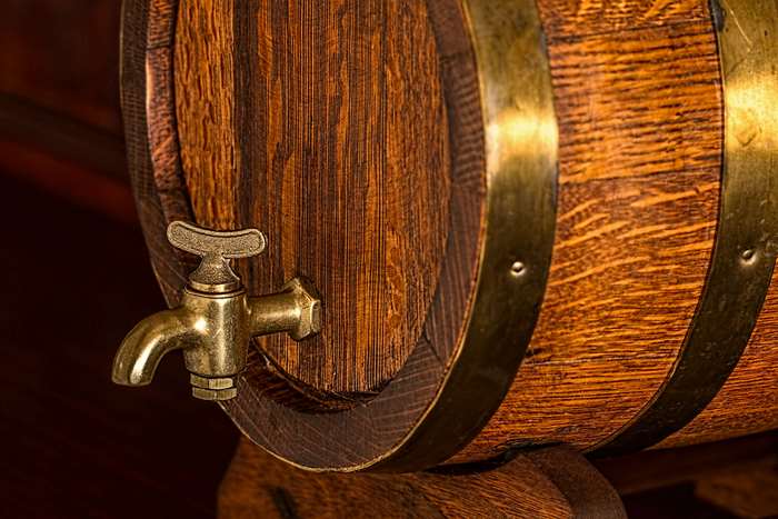 Wooden barrel with brass hoops and tap