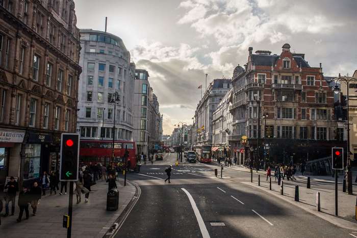 London street with red bus and traffic lights 4K