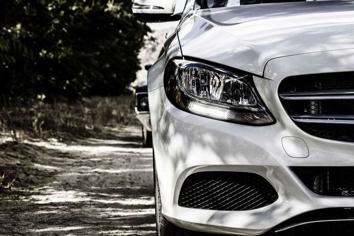 Mercedes-Benz car headlight on a dirt road