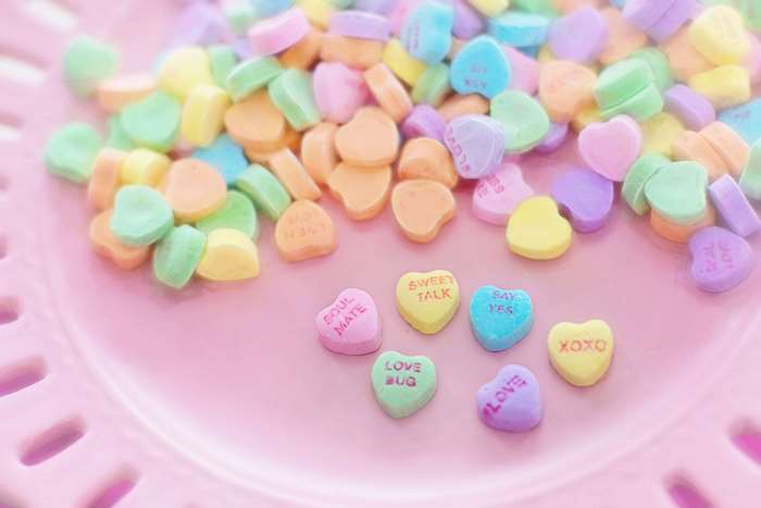 Valentine candy hearts on a pink plate 4K