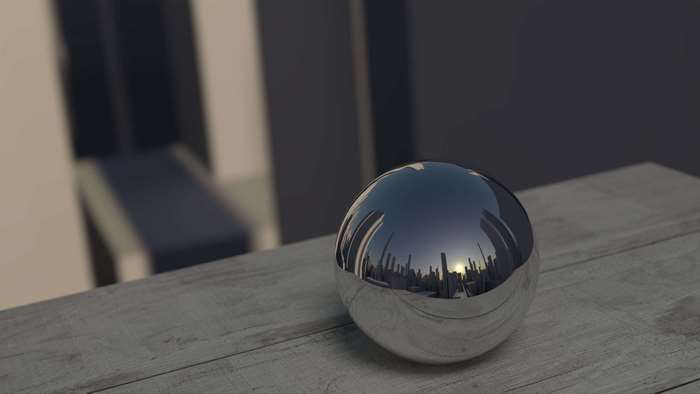 Shiny metal ball reflecting city at sunset on wooden table