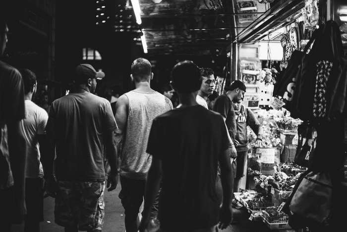 People walking through a market at night