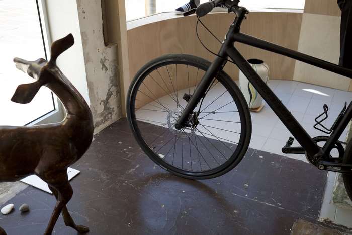 Black minimalist bicycle in a store with a deer decoration