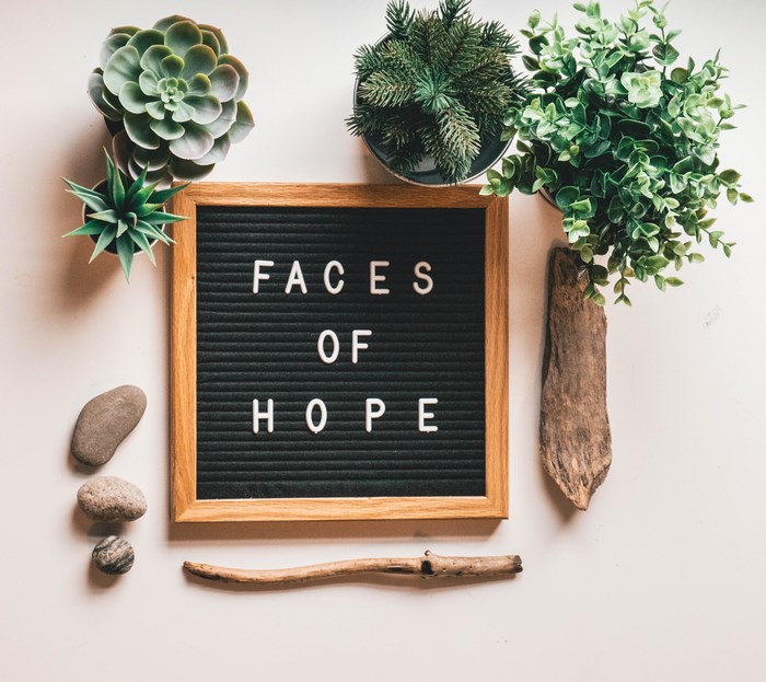 Letterboard with "Faces of Hope" and plants