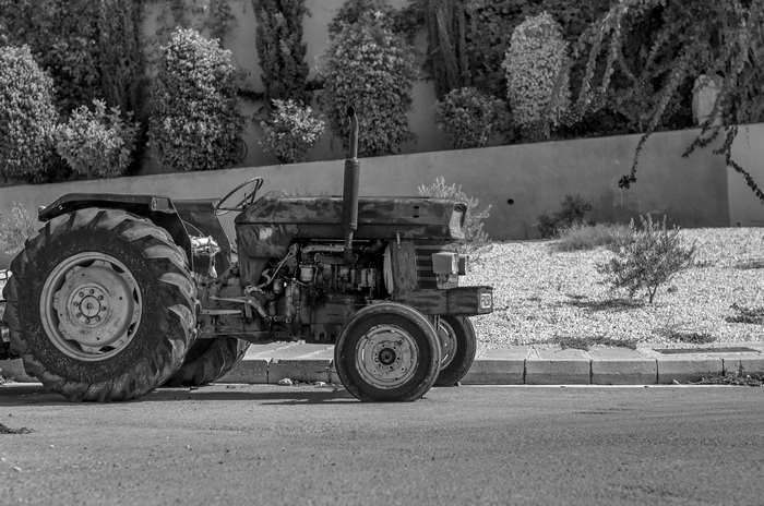 Old abandoned tractor in black and white