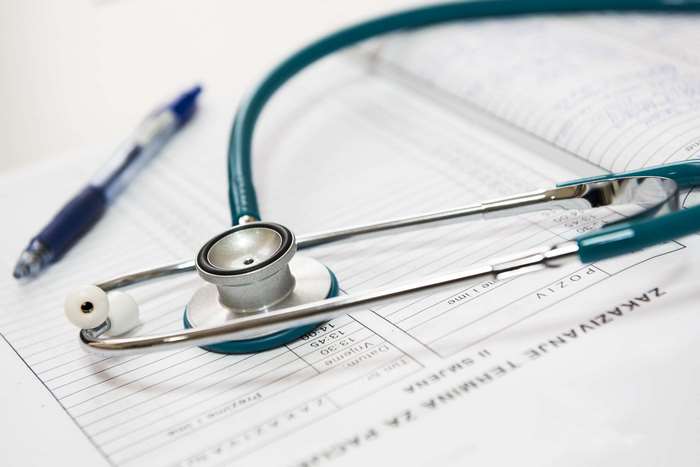 Stethoscope and Pen on Medical Appointment Paper