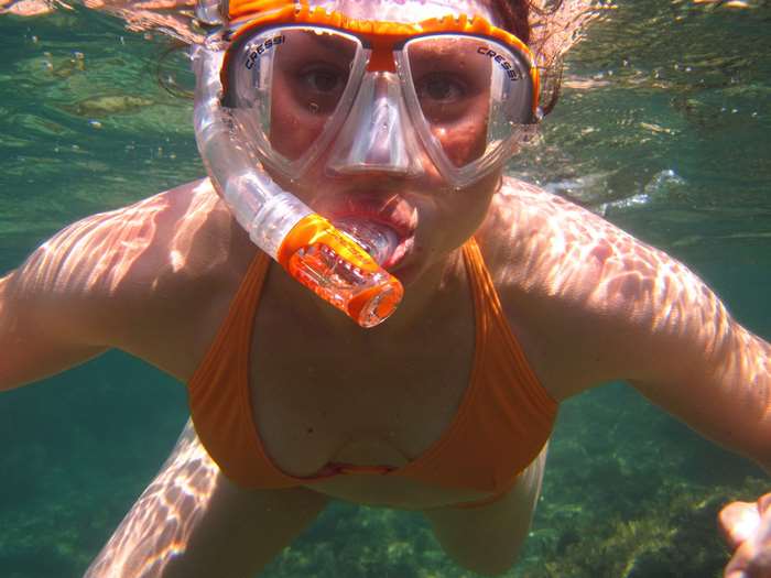 Woman snorkeling underwater with Cressi mask
