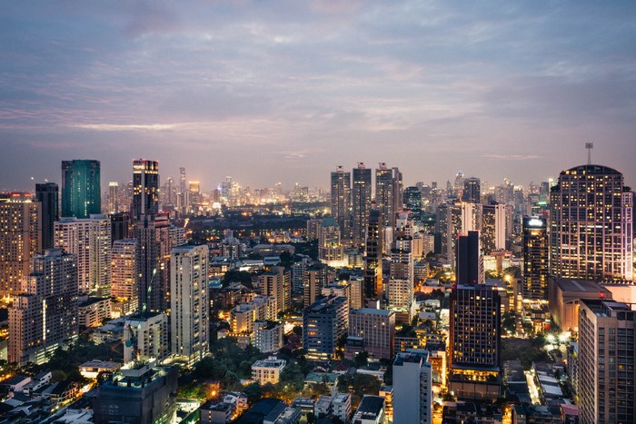 Bangkok cityscape at dusk with illuminated skyscrapers