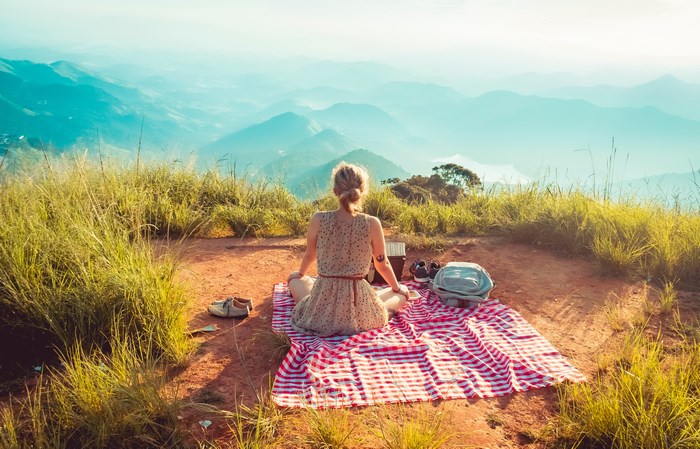 Woman enjoying a picnic with a mountain view