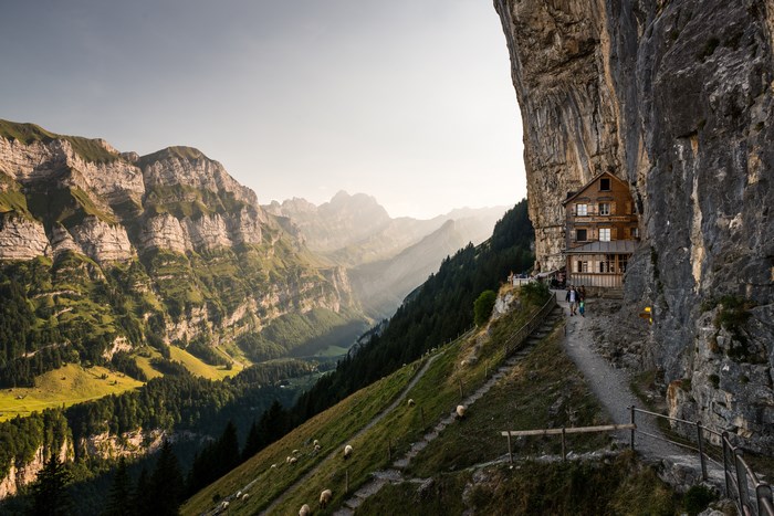 House built into a cliff face in the mountains