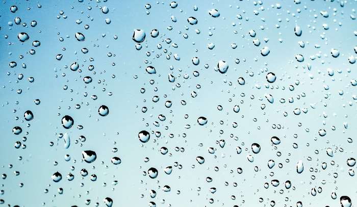 Close-up of water droplets on a blue surface