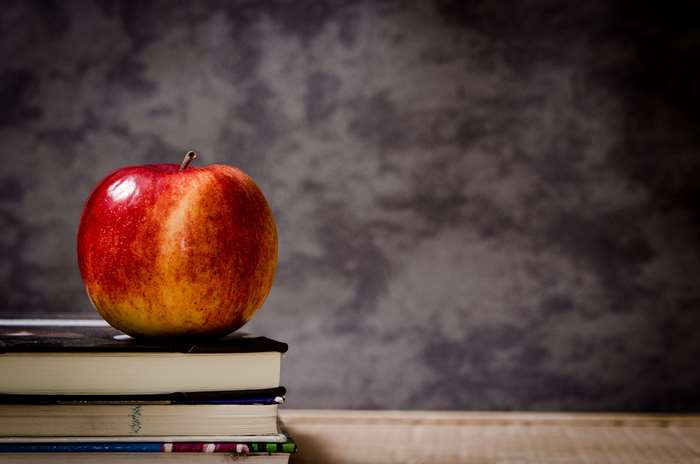 Red apple on a stack of books