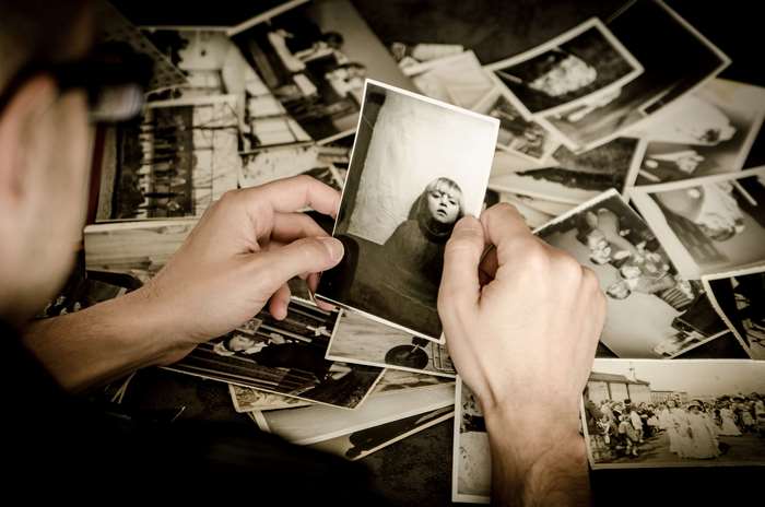 Person looking at old photographs