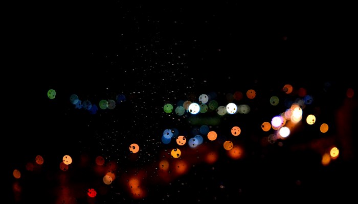 Bokeh lights on a wet window at night
