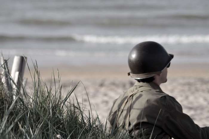 Soldier in helmet on beach, World War II commemoration
