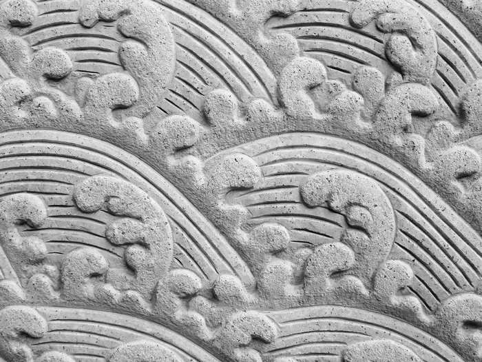 Stone carving of stylized waves