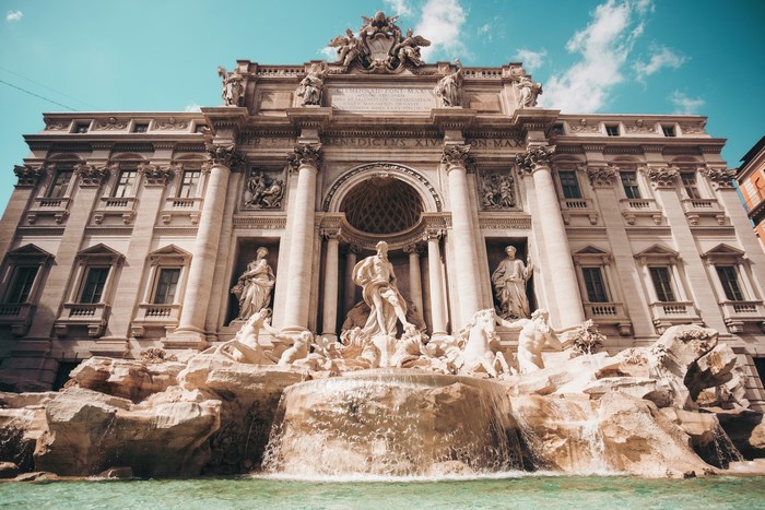 Trevi Fountain with statues and water in Rome