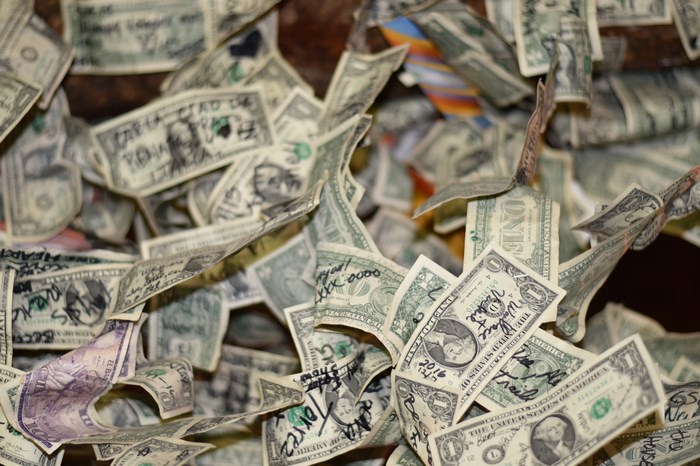 Defaced Dollar Bills Scattered