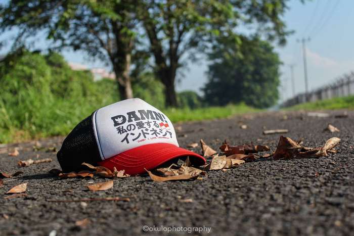 Damn Indonesia trucker cap on asphalt road
