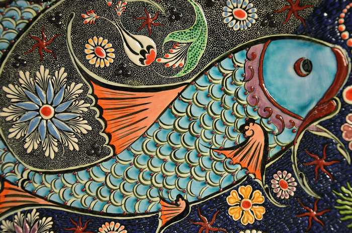 Colorful ceramic tile with fish and floral patterns