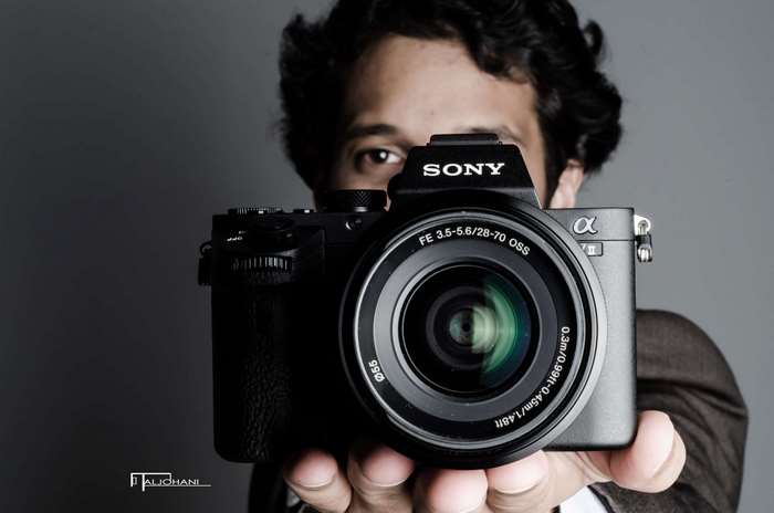Man holding a Sony Alpha camera