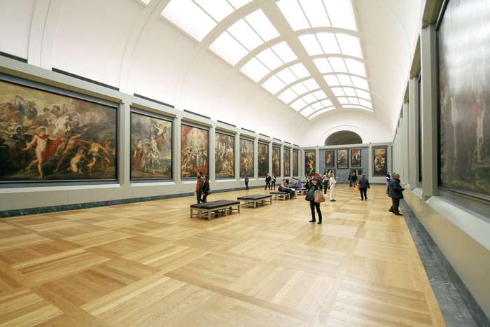 Art gallery with paintings and visitors