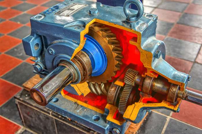 Cutaway view of a blue industrial gearbox with gears