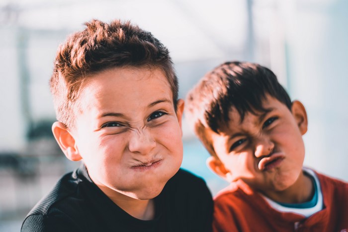 Two boys making funny faces outdoors