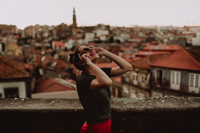 Woman in sunglasses and red skirt in Porto