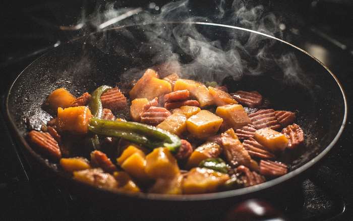 Vegetables cooking in a frying pan 4K