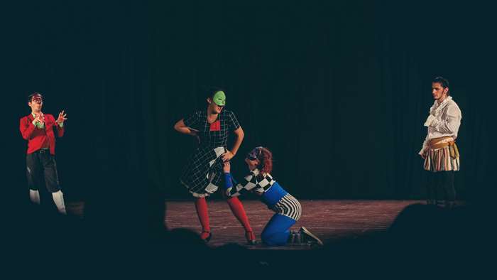 Theater play with masked actors in costumes