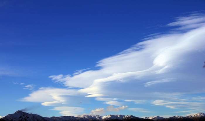 Mountains under a blue sky with clouds