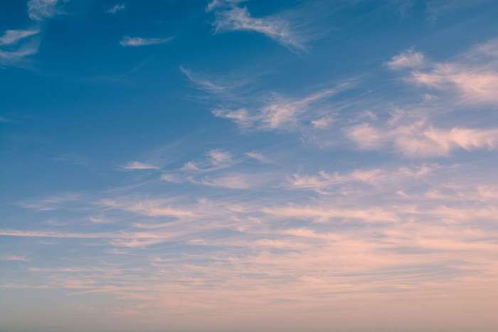 Wispy clouds in a blue and pink sky 4K