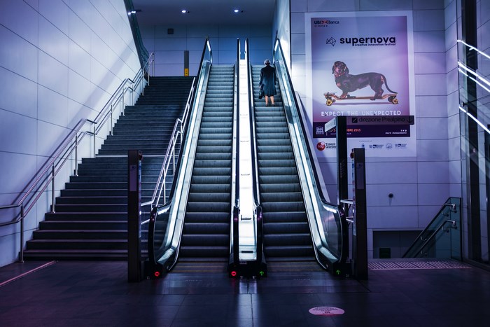 Person on escalator in modern urban station