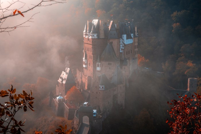 Eltz Castle in Germany shrouded in fog during autumn
