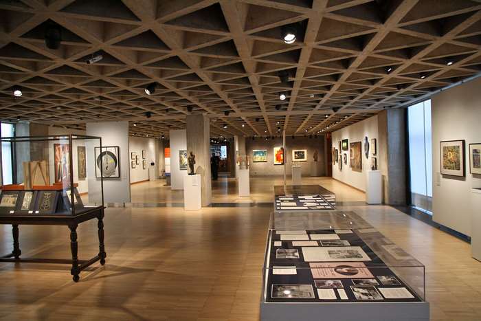 Art gallery interior with display cases and paintings
