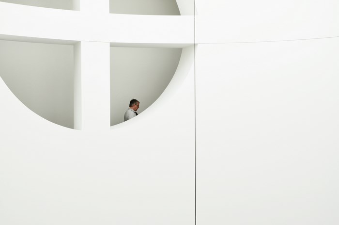 Man in a white architectural space
