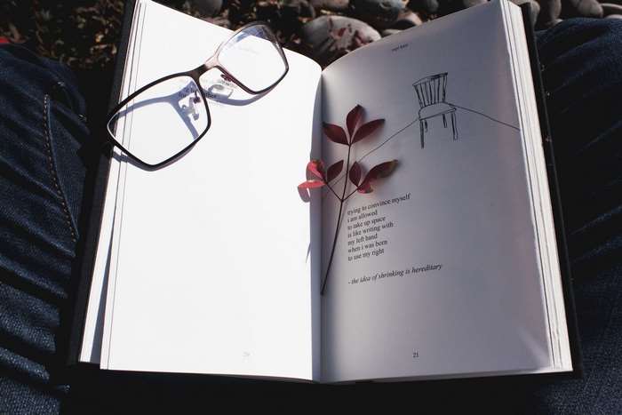 Book with glasses and leaf, poetry page