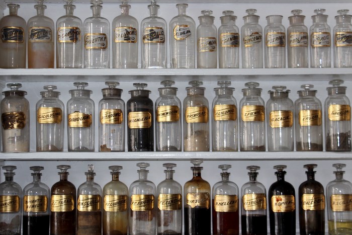 Vintage apothecary bottles on shelves